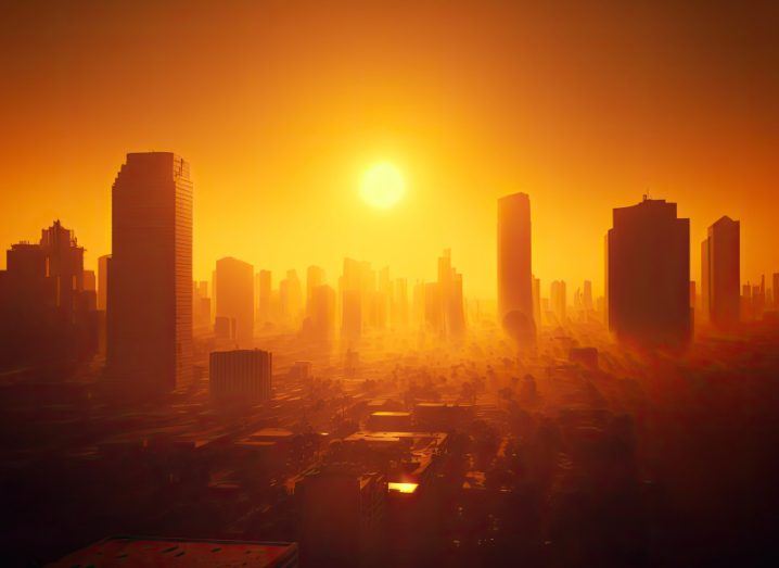 Illustration of a city with the sun shining overhead and an orange glow emanating out from it. Used to show the concept of rising temperatures and the climate crisis.