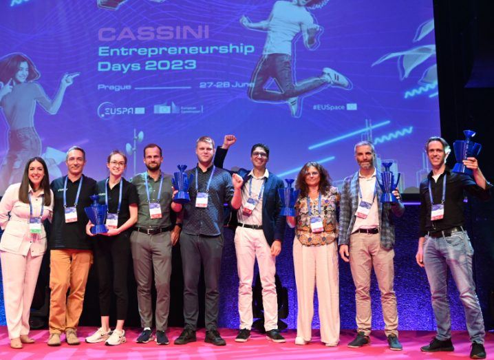 A group of people standing on a stage having won the 2023 EU space competition that was run by EUSPA.