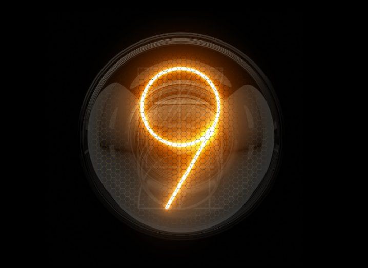 The number nine shines bright in lights against a dark background.